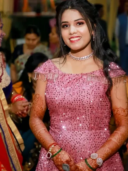 A candid shot of the client enjoying her event in the sparkly pink gown.