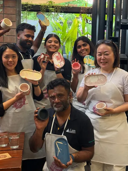 The proud creators from the Lam Research team showing off their finished Jesmonite pieces. From coasters to trays, each item is a unique, handmade treasure.