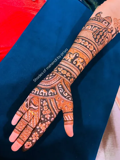 A rich and dense bridal design with a focus on elephant motifs, a symbol of good luck and prosperity.