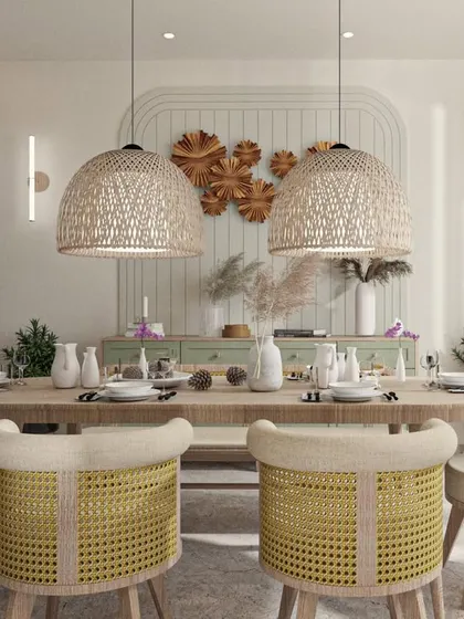 A Japandi-style dining room with woven pendant lights, cane-back chairs, and a simple wooden table.