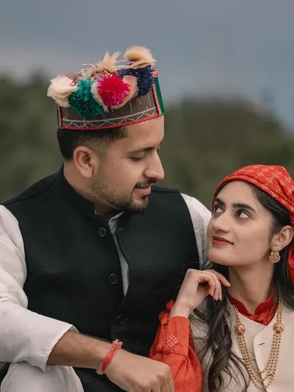 A beautiful portrait of a couple in traditional Himachali attire, celebrating their heritage amidst the natural beauty of the mountains. This is what I call authentic 'Pahari love'.