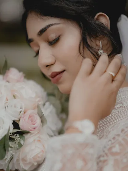 A close-up of a Christian bride, her eyes closed, holding her bouquet in a moment of serene reflection.