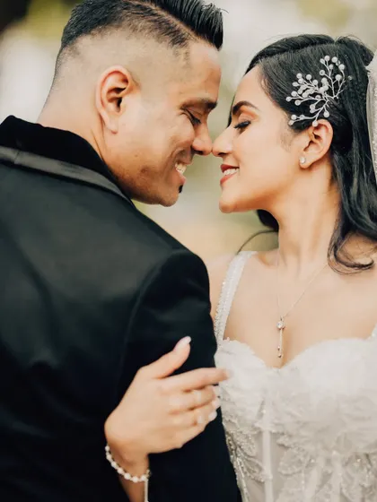 A happy, close-up moment between the bride and groom. This candid portrait captures their genuine smiles and the excitement of their wedding day.