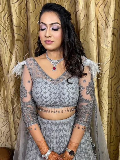 A full view of the soft glam engagement look. The feathered details on the grey lehenga are complemented by the subtle shimmer on her eyes and the radiant skin finish.