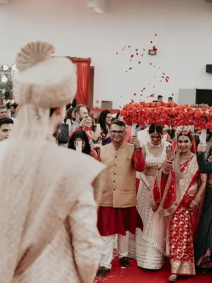 The bride's grand entrance. This shot is taken from the groom's perspective, capturing his view as his bride walks towards him, a beautiful and emotional moment.