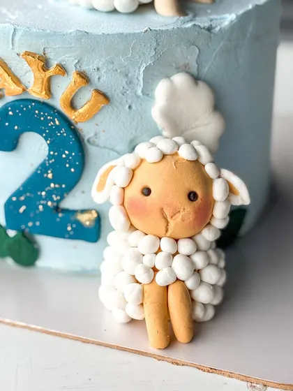A detailed shot of one of the white sheep toppers next to the number '2'.