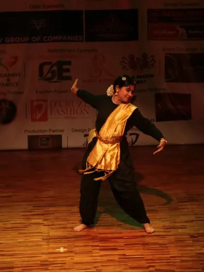 A solo dancer mid-performance on the wooden stage.
