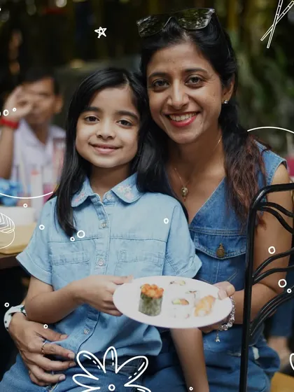 A mother and daughter proudly show off the sushi they made together. Our workshops are a wonderful way to bond and create lasting memories with loved ones.