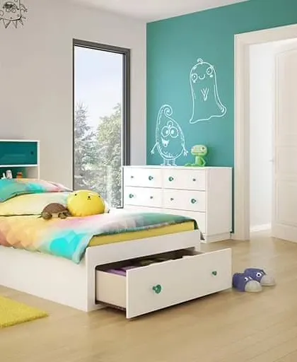 A bright and cheerful kid's room with a teal accent wall, fun monster decals, and a bed with built-in storage drawers.