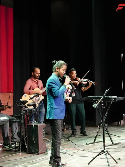 A full band, including a vocalist, violinist, and keyboardists, performs at the CSN School Annual Recital in Pune. This demonstrates the orchestral and ensemble opportunities we create for students.