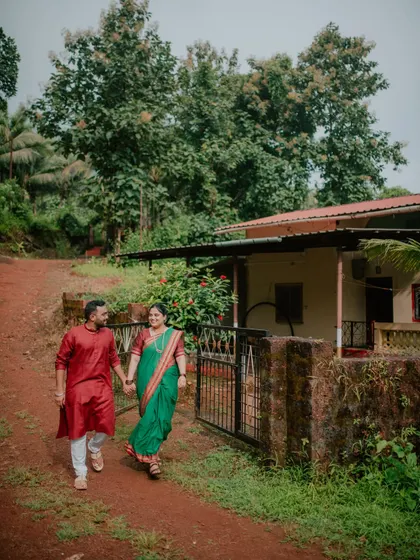 A candid walking shot of a couple in a rural village setting for their pre-wedding photoshoot.
