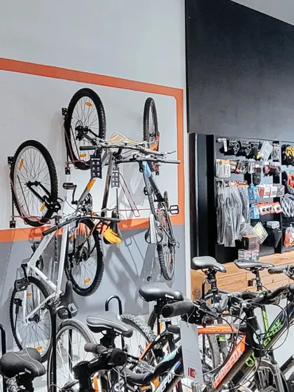 Wall-mounted racks are a space-efficient solution for displaying bicycles. This setup keeps the floor clear and creates an organized, grid-like visual that is easy for customers to browse.