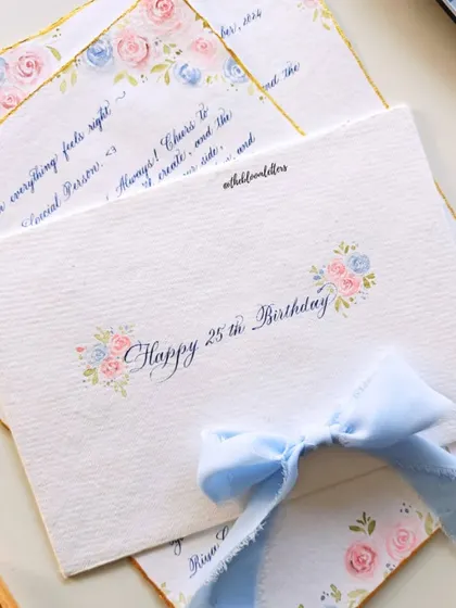 The back of the hand-painted envelope, with "Happy 25th Birthday" written in calligraphy, surrounded by small floral details.