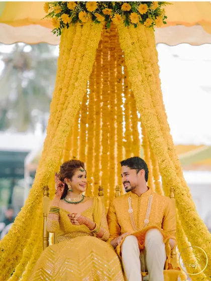 A lovely candid moment between the couple during their vibrant yellow-themed Haldi ceremony.