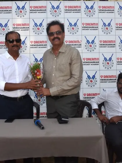 Presenting a bouquet to a guest of honor at the Dream11 Cup prize distribution.
