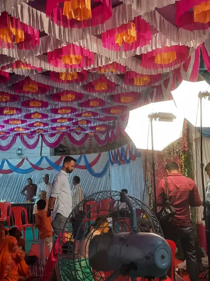 A behind the scenes look at a Haldi event setup. You can see the decorated pandal ceiling and my team getting the final details right.