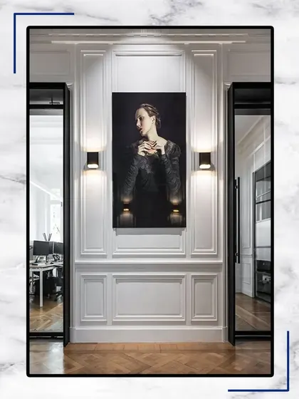 We adorn our spaces with exceptional walls and furniture. This design concept features a classic portrait on a paneled wall, creating a sense of timeless artistry.