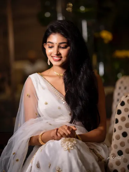 A seated portrait that feels intimate and sweet. The soft lighting and gentle smile create a serene and beautiful image.