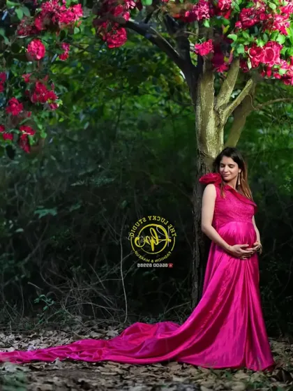 A beautiful outdoor maternity shoot in a forest setting. I provided this vibrant magenta satin gown with a long trail that drapes beautifully for stunning photos.