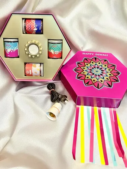This vibrant, hexagon-shaped lantern box was a popular choice for Diwali. It's filled with beautifully packaged scented candles and comes with a light fixture, offering a gift that lasts beyond the festival.
