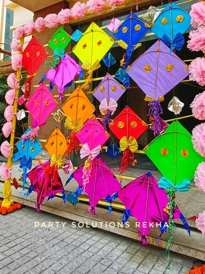 A creative photo backdrop made of colorful kites. This is a perfect theme for a spring wedding or a fun, playful event, adding a unique and festive touch.
