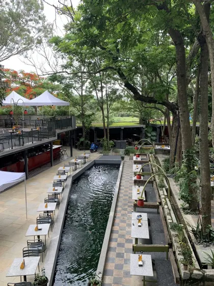 This view showcases the scale of our outdoor restaurant and its beautiful integration with the surrounding landscape and water features.