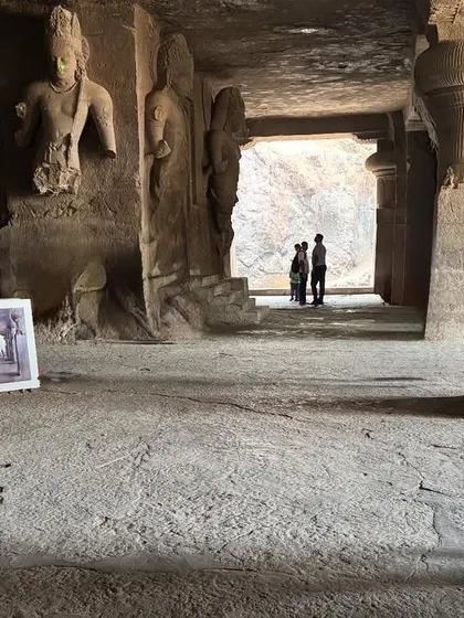 Holding the finished painting inside the Elephanta Caves. It's a surreal feeling to capture a scene and then hold it up against the real thing.