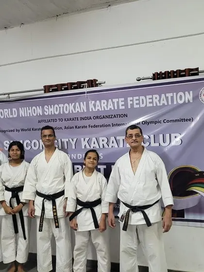 Our senior black belt instructors and students stand before the World Nihon Shotokan Karate Federation banner during a recent belt exam at the Silicon City dojo.