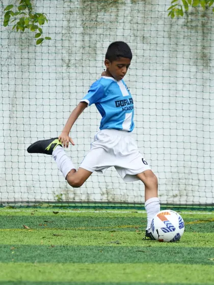 Perfecting the kicking technique. This action shot captures the form and power we teach our players to develop in their striking ability.