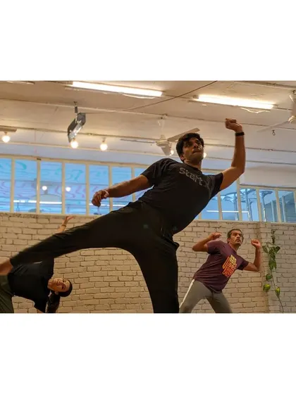 A powerful kick from a student during a dynamic part of the choreography.