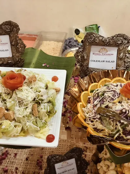 Another look at my Caesar and coleslaw salads, showing the detailed presentation with tomato and orange garnishes.