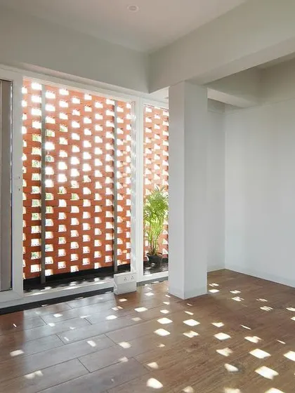 In my "House Belaku" project, I used a brick *jali* screen to transform sunlight into a dynamic design element. This image captures how the perforated brickwork casts a beautiful, shifting mosaic of light and shadow, creating a serene atmosphere while ensuring privacy.