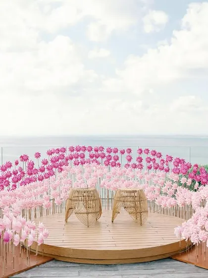 A picturesque installation of pink pinwheels at 'Villa Brissa', set against the Bali sea. As the sea breeze blew, the pinwheels came to life, swaying gracefully to the rhythm of the wind.