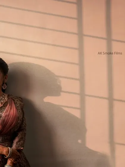 An artistic portrait of the bride using natural light and shadows from a window for a dramatic effect.