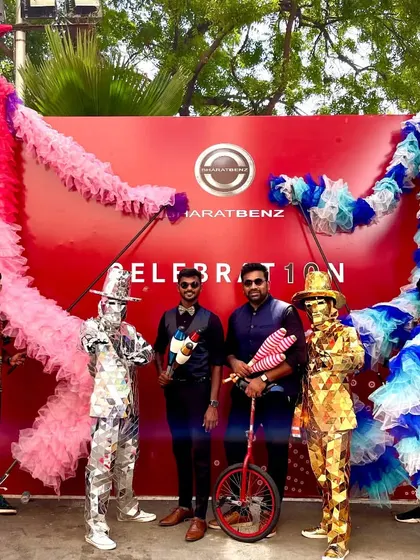 Our multi-talented team poses for a photo at a corporate event for BharatBenz. This shot features our juggler and unicyclist alongside stilt walkers and Mirror Men, showcasing the variety we offer.