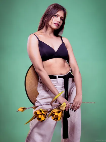 A full-body shot of the model against a green background, creating a vibrant contrast.