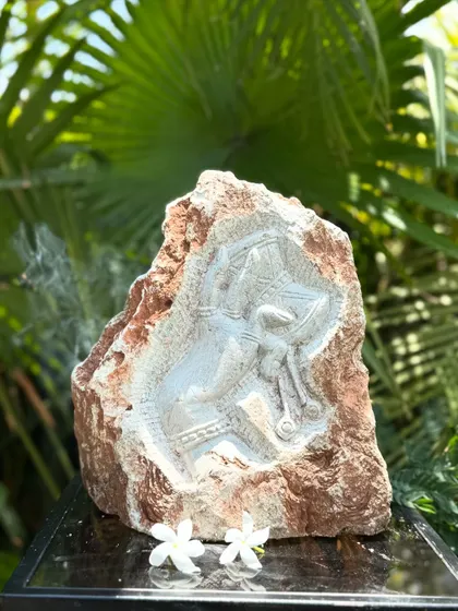 A niche carving in natural rock, depicting a deity. These sculptures, inspired by South Indian temples, add a touch of spirituality and artistry to gardens and homes.