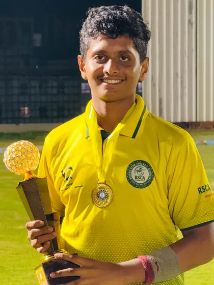 A smiling player with his trophy and medal, a reward for his excellent performance.
