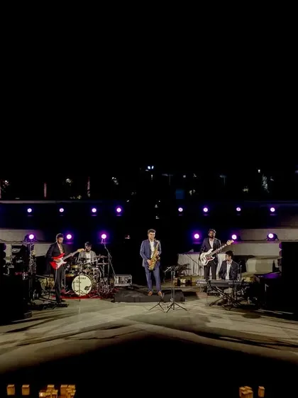 A live band performs on a grand stage at the Amitarasa amphitheater, providing incredible entertainment for the wedding reception.