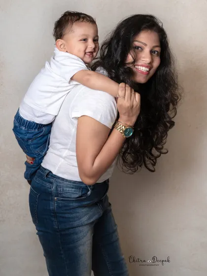 A sweet mother and son portrait, with the little boy getting a piggyback ride, showcasing a natural and loving bond.