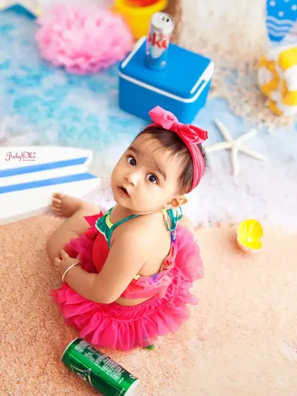 An overhead view of our little beachgoer. The 'sand' and 'water' in the studio create a realistic and immersive beach scene for photos.