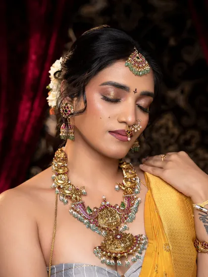 A moment of quiet elegance, showcasing a unique antique necklace with Kempu and pearl accents. This piece is inspired by temple art and adds a touch of heritage to a modern look.