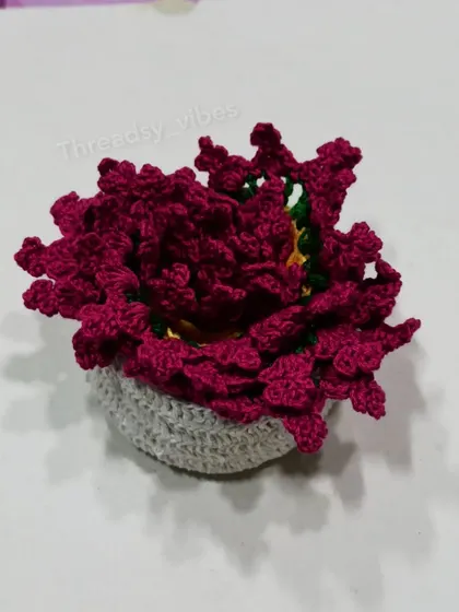 This is the crocheted holder I provide with my coaster sets, filled with the floral coasters. It keeps everything tidy and looks cute on a shelf.