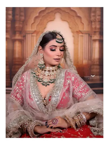 A seated portrait that captures a moment of quiet reflection. The soft lighting and the bride's gentle pose create a timeless and elegant image.