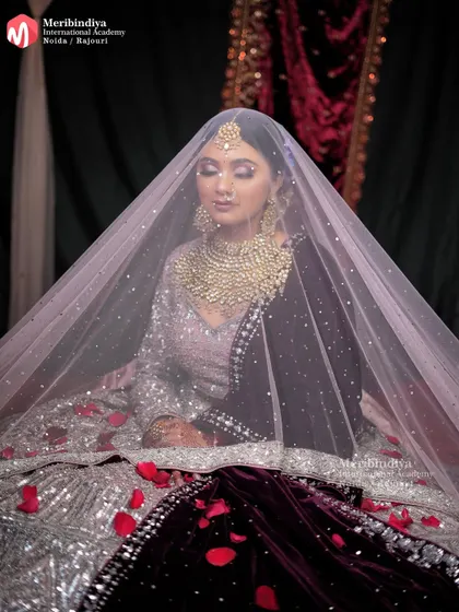 Here, the hairstyle is designed to beautifully accommodate a sheer veil, a crucial skill for any professional bridal stylist.