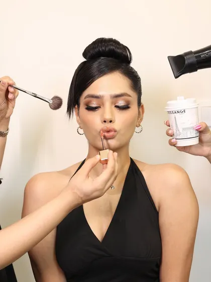 We now offer curated hair and makeup experiences. This shot captures the full glam process, with a team of artists working to create the perfect look.