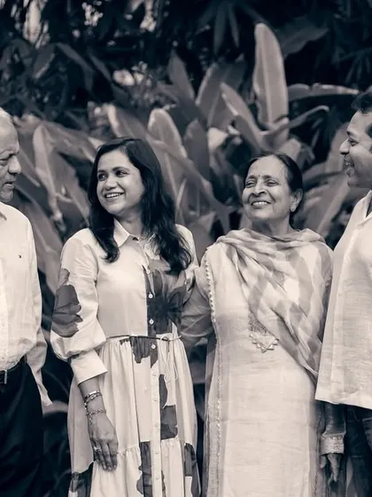 A candid black and white shot of a family interacting, focusing on the relationships and emotions within the group.