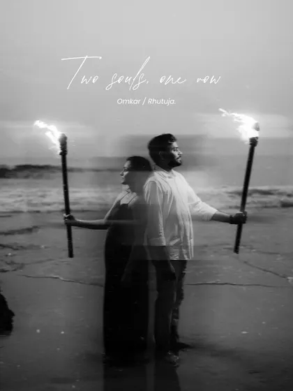 A creative double-exposure image in black and white, showing a couple with torches on a beach. The text "Two souls, one now" adds a romantic, artistic touch to this unique save-the-date photo idea.