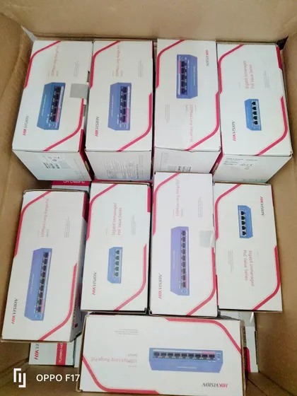 A box of Hikvision PoE (Power over Ethernet) switches, ready for installation. These switches are essential for IP camera systems, as they provide both network connectivity and power to the cameras through a single cable.