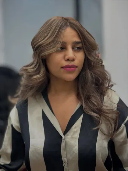 A three-quarter view of the caramel brown hair, styled with soft waves to enhance the color's dimension.